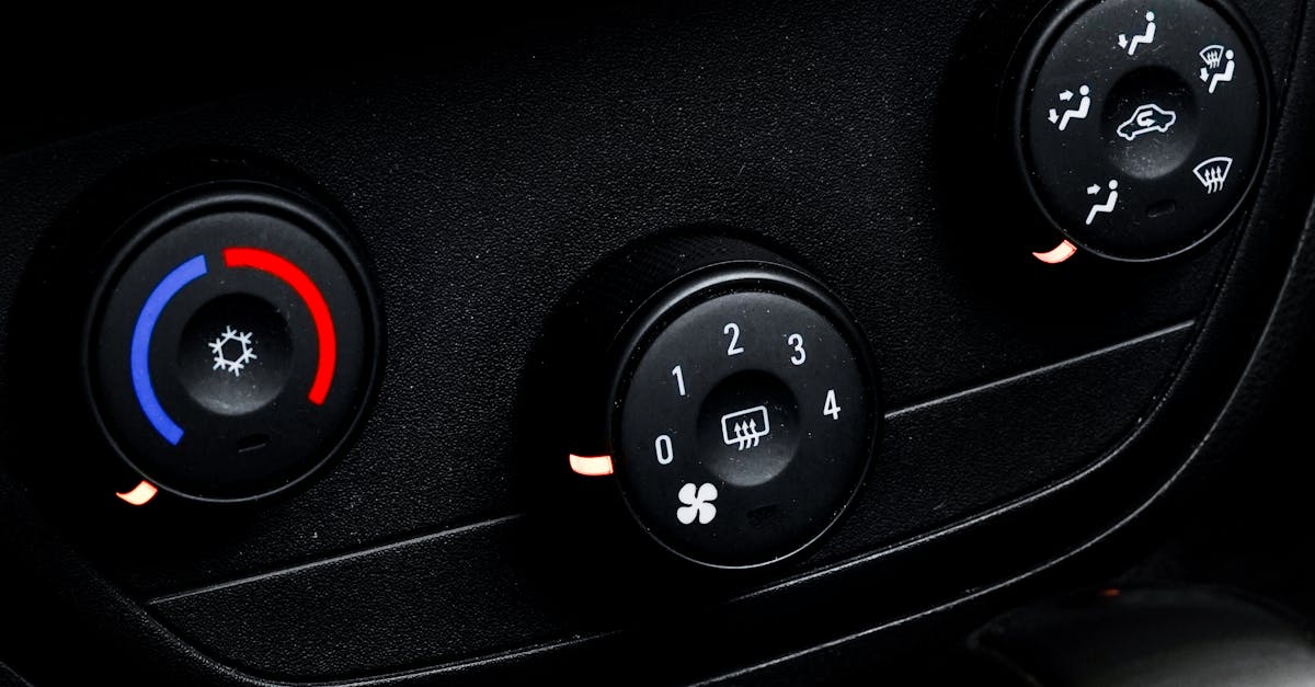 Detailed close-up of air conditioning and ventilation controls in a car interior.